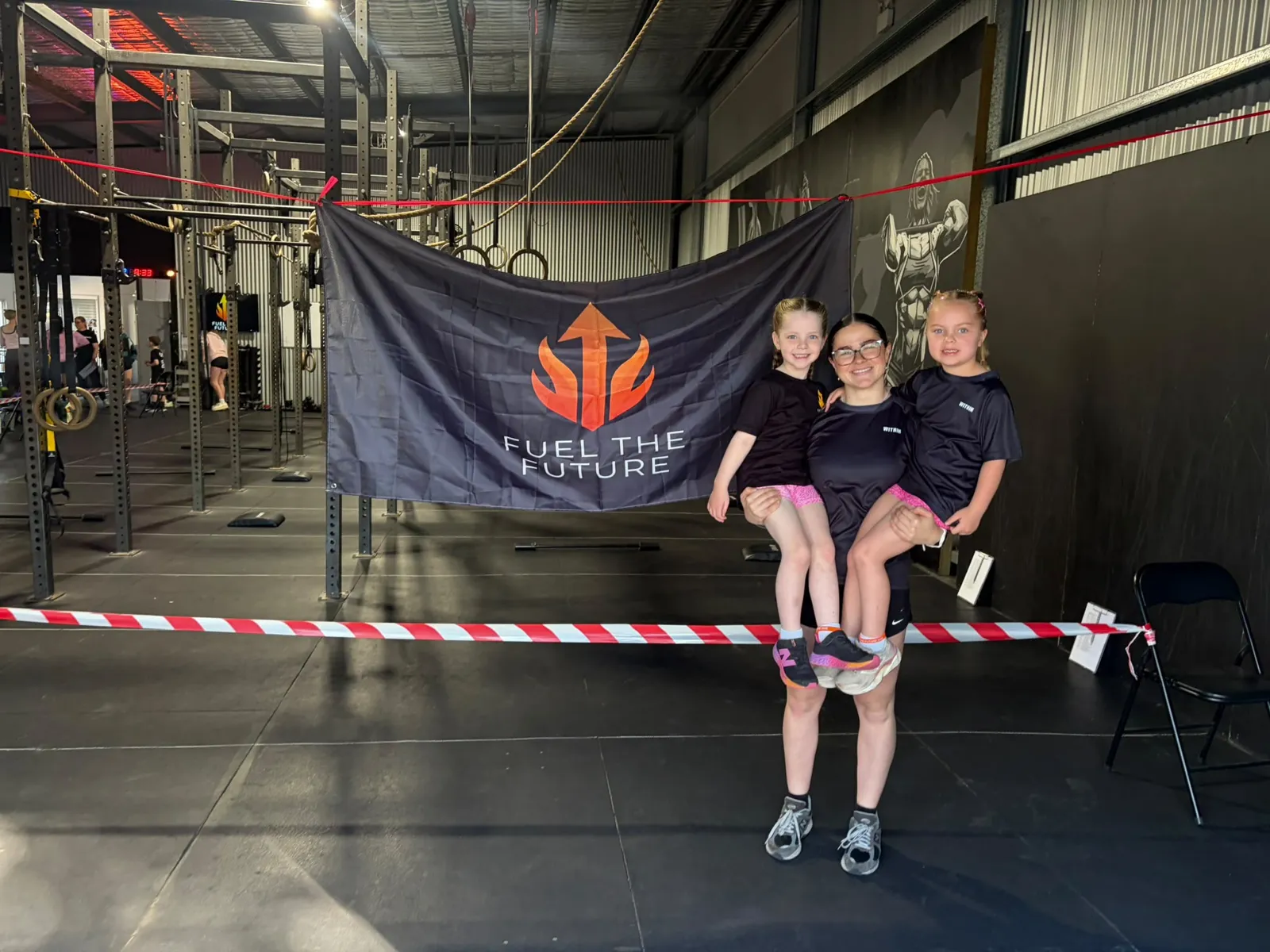 Dayna with two young WITHIN members on the gym floor